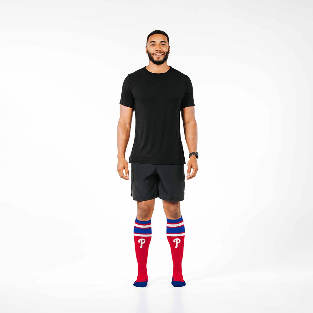 Man wearing PRO Compression Major League Baseball Knee High Compression Sock Genuine MLB Merchandise Sock Philadelphia Phillies