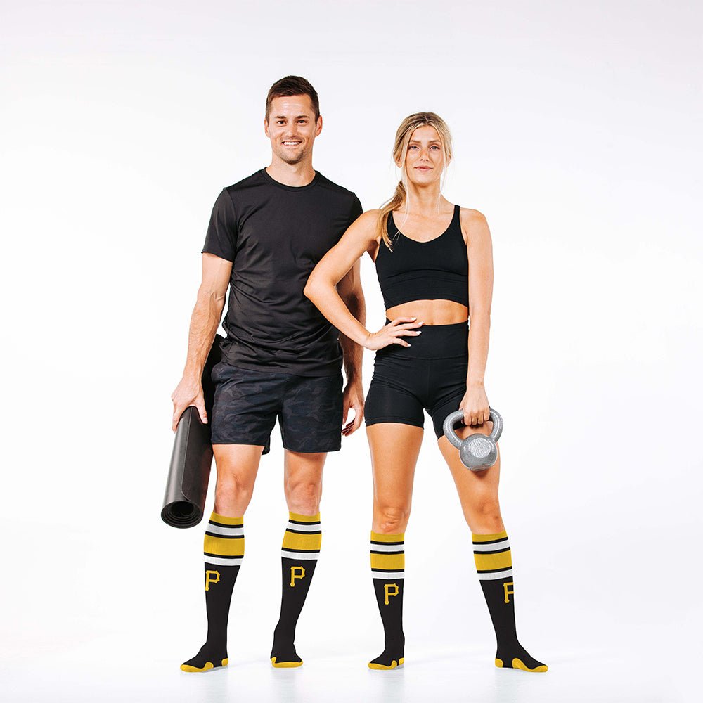 Man and woman wearing PRO Compression Major League Baseball Knee High Compression Sock Genuine MLB Merchandise Sock Pittsburgh Pirates