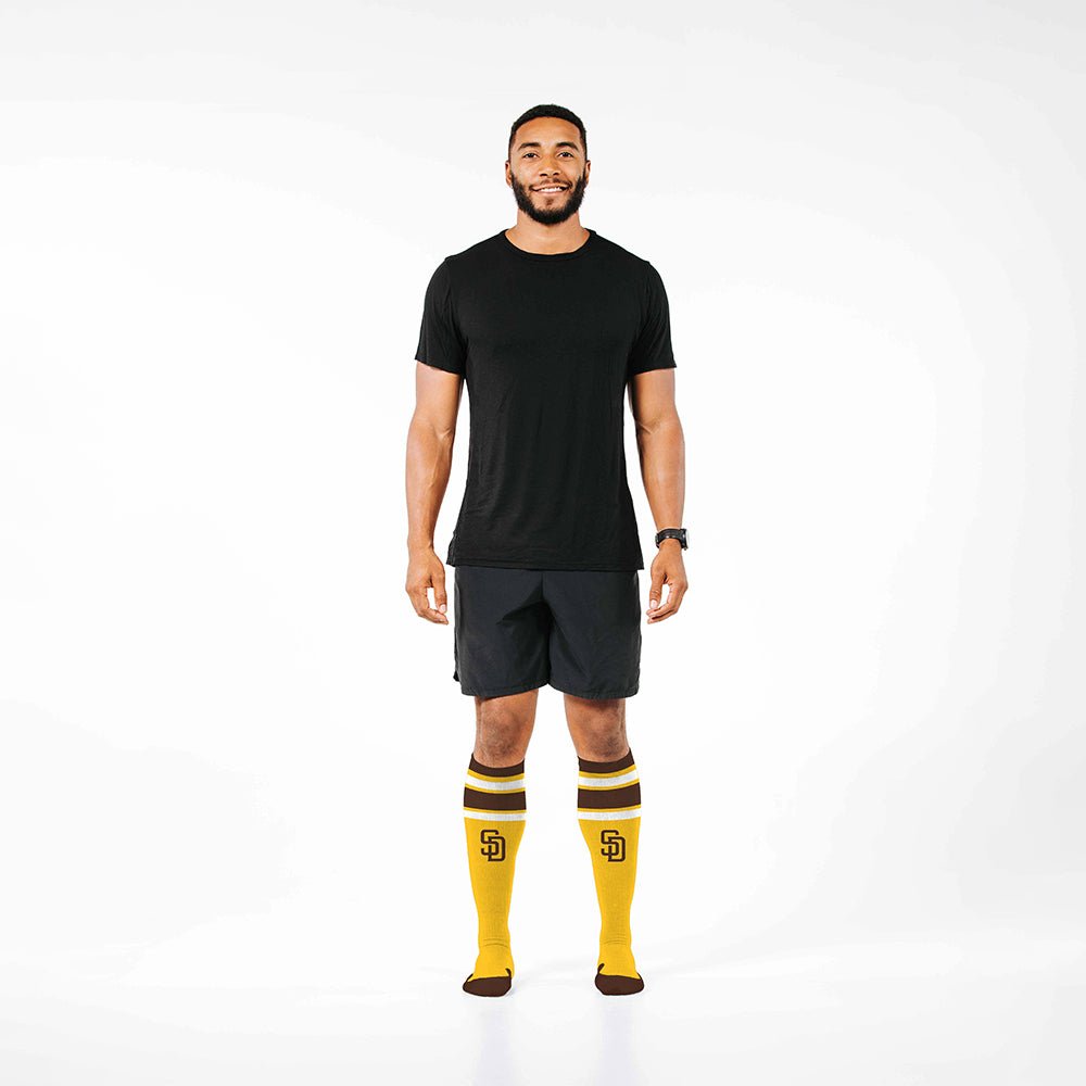 Man wearing PRO Compression Major League Baseball Knee High Compression Sock Genuine MLB Merchandise Sock San Diego Padres