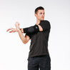 Man stretching with PRO Compression Elbow Sleeve