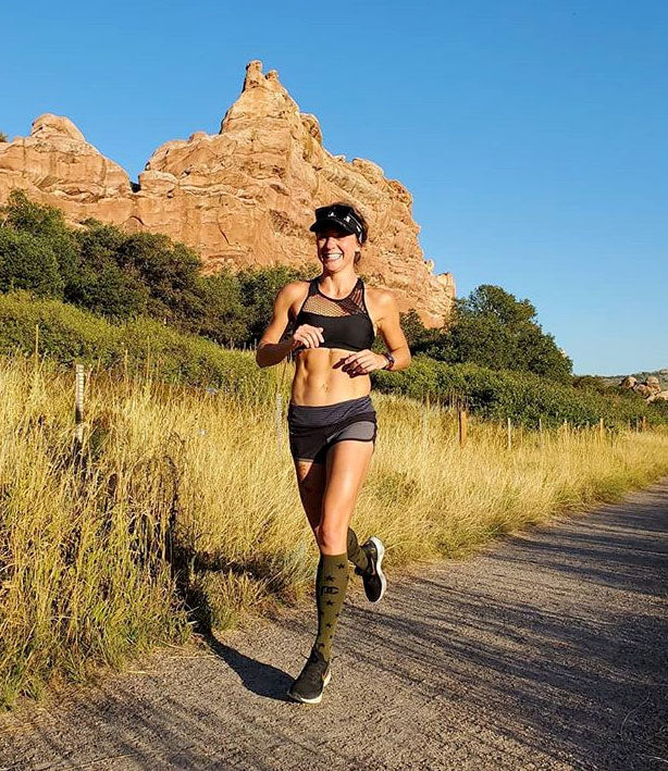 Female runner wearing PRO Compression Knee High Running Compression Socks.