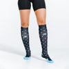 Knee high compression socks in navy blue with light blue dots on model close up
