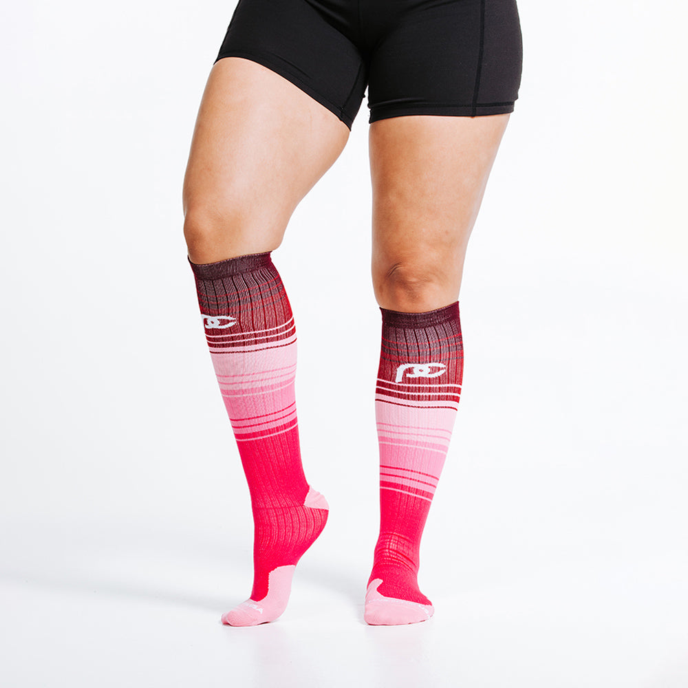 pink and rose colored knee high compression socks - close up feet