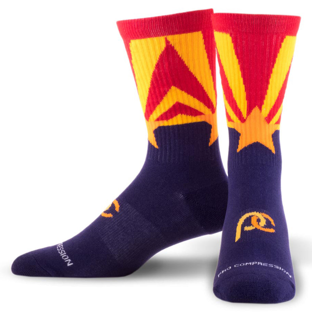 Crew length compression socks with navy blue, red, and golden star design - Product close up