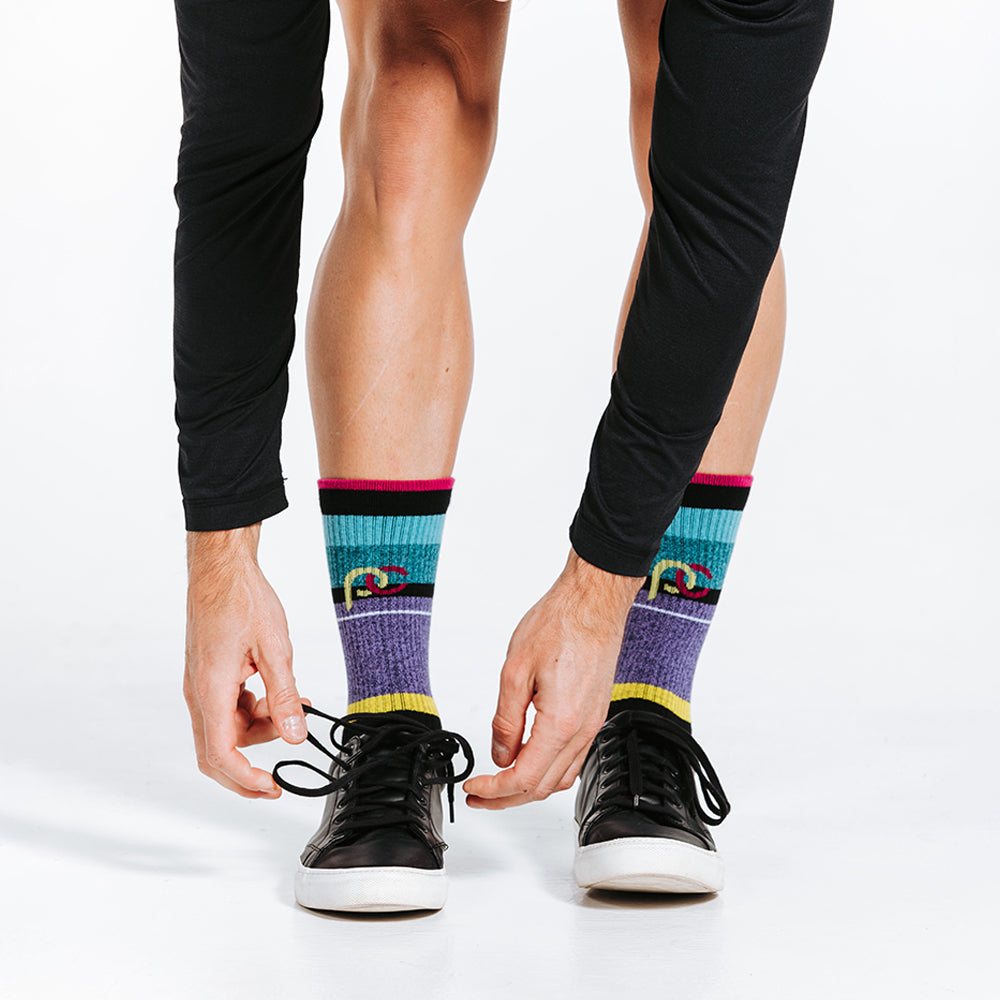 Striped colorful crew socks woven with lightweight compression for relaxed days - on model with shoes
