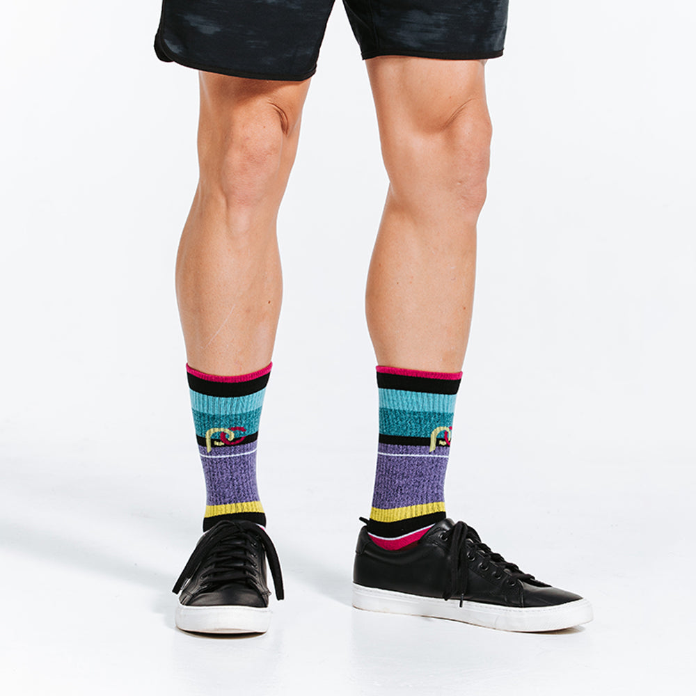 Striped colorful crew socks woven with lightweight compression for relaxed days - close up on socks and shoes