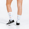 White compression socks with faded red and purple polka dots - close up on model wearing Vans shoes (rear view)