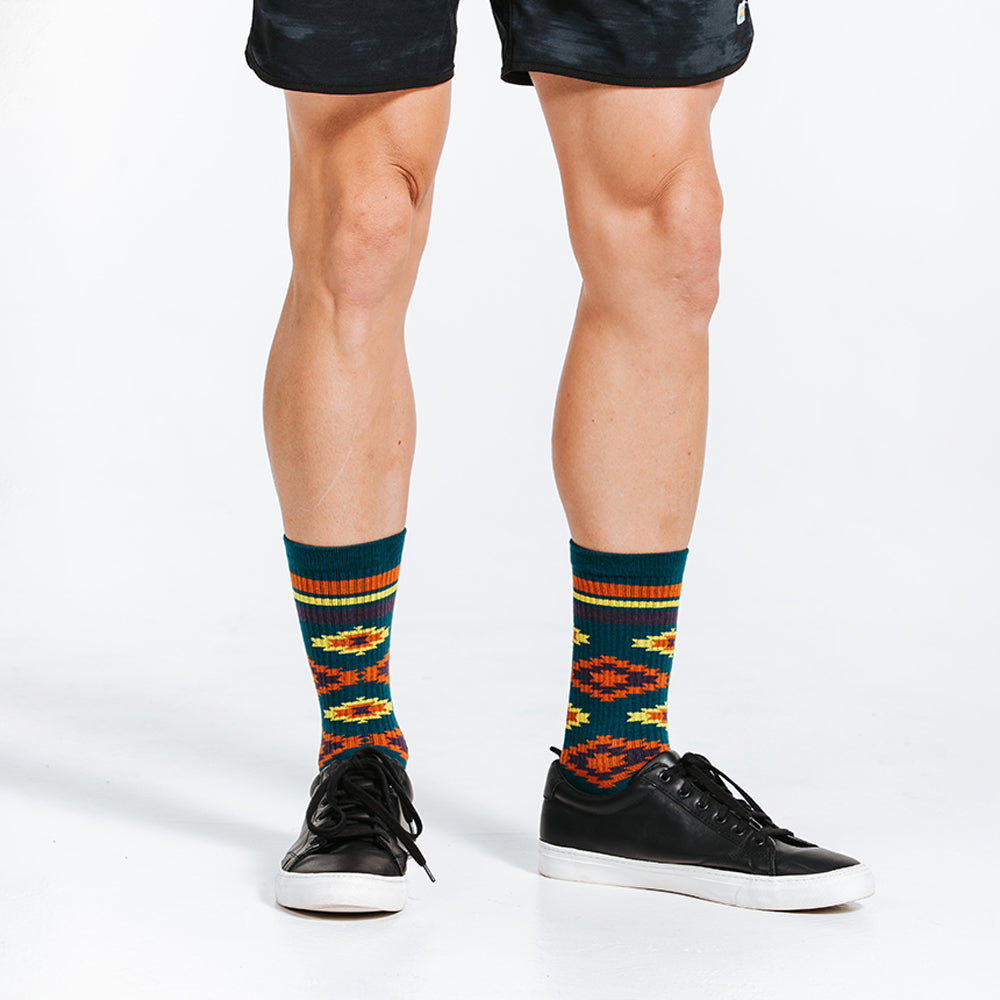 Compression crew socks with green Aztec design - close up on model