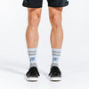 Grey and blue crew length compression socks for men and women - feet close up