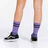 Purple socks with gold details, made with lightweight graduated compression - rear view of model feet