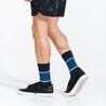 Blue crew length compression socks with white bands