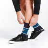 Blue crew length compression socks close up on model