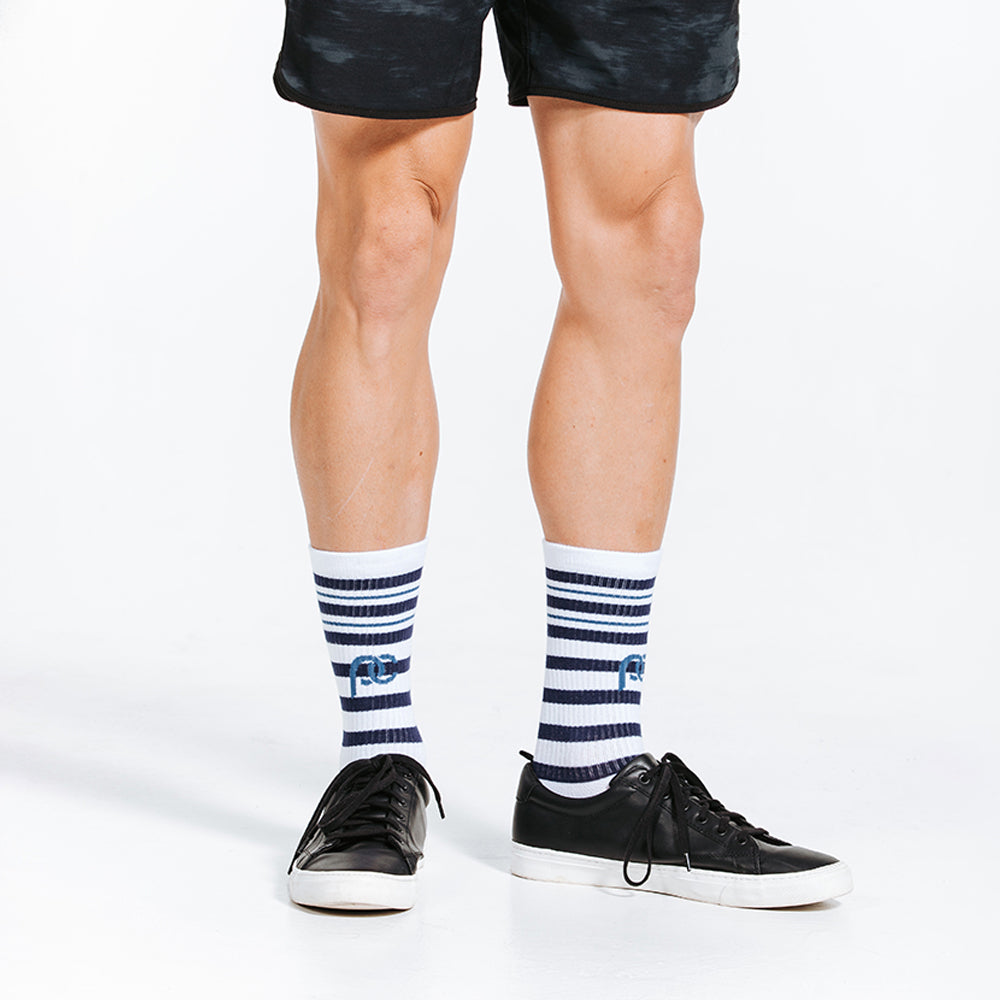 Blue and white striped compression socks - crew length - standing close up on feet