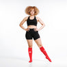 Knee-high Recovery Compression Sock 25-35 mmHg | Female wearing red knee high compression socks