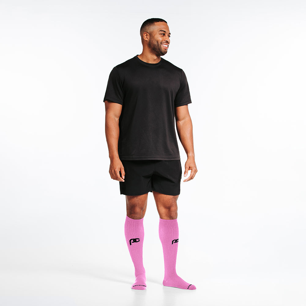 Knee-high Recovery Compression Sock 25-35 mmHg | male wearing rose pink knee high compression socks