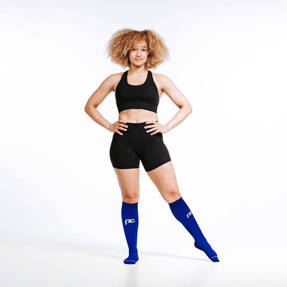 Knee-high Recovery Compression Sock 25-35 mmHg | Female wearing royal blue knee high compression socks