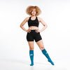 Knee-high Recovery Compression Sock 25-35 mmHg | Female wearing turquoise knee high compression socks