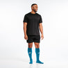 Knee-high Recovery Compression Sock 25-35 mmHg | Male wearing turquoise knee high compression socks
