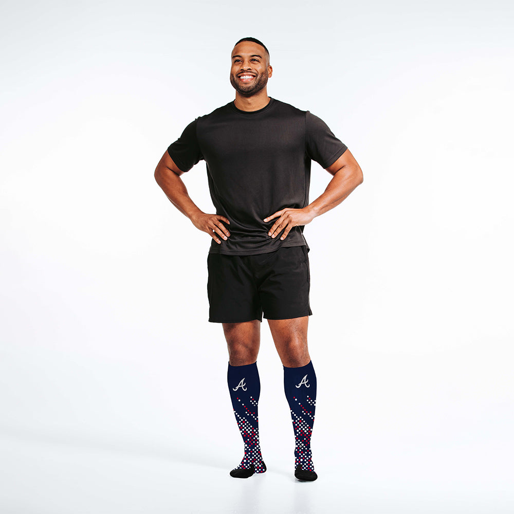 Man wearing PRO Compression Major League Baseball Knee High Compression Sock Genuine MLB Merchandise Sock Atlanta Braves