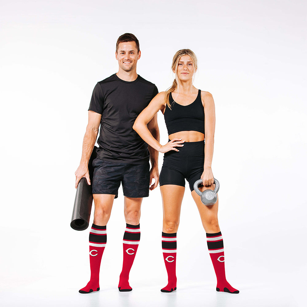 Man and woman wearing PRO Compression Major League Baseball Knee High Compression Sock Genuine MLB Merchandise Sock Cincinnati Reds