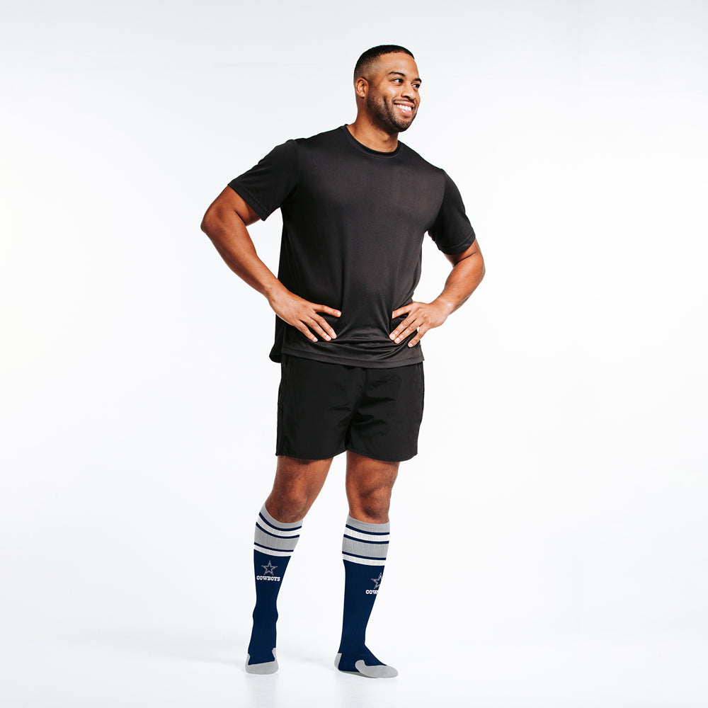 Male model wearing Dallas Cowboys officially-licensed NFL Knee-high Compression Socks