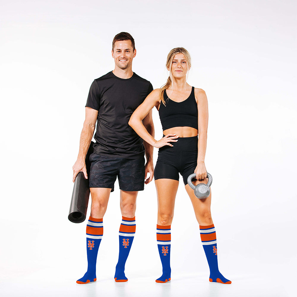 Man and woman wearing PRO Compression Major League Baseball Knee High Compression Sock Genuine MLB Merchandise Sock New York Mets